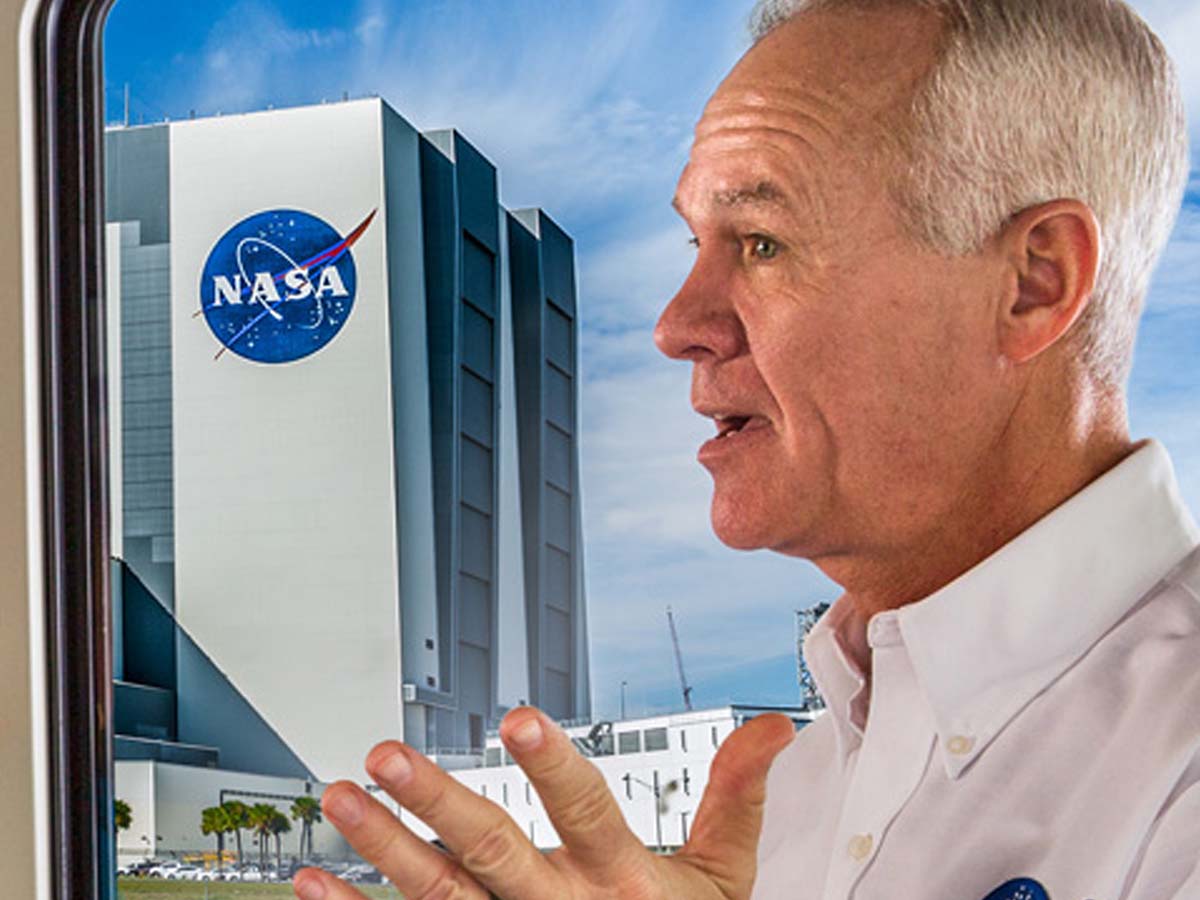 1200x900GMB-2 Tour guide speaks to visitors on a bus while passing by NASA buildings during the Kennedy Space Center Bus Tour.