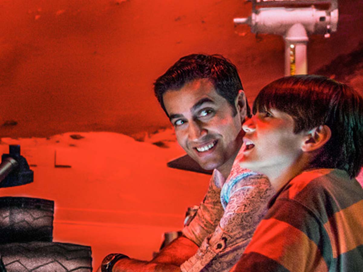 Father and son look at the Journey to Mars exhibit at Kennedy Space Center.