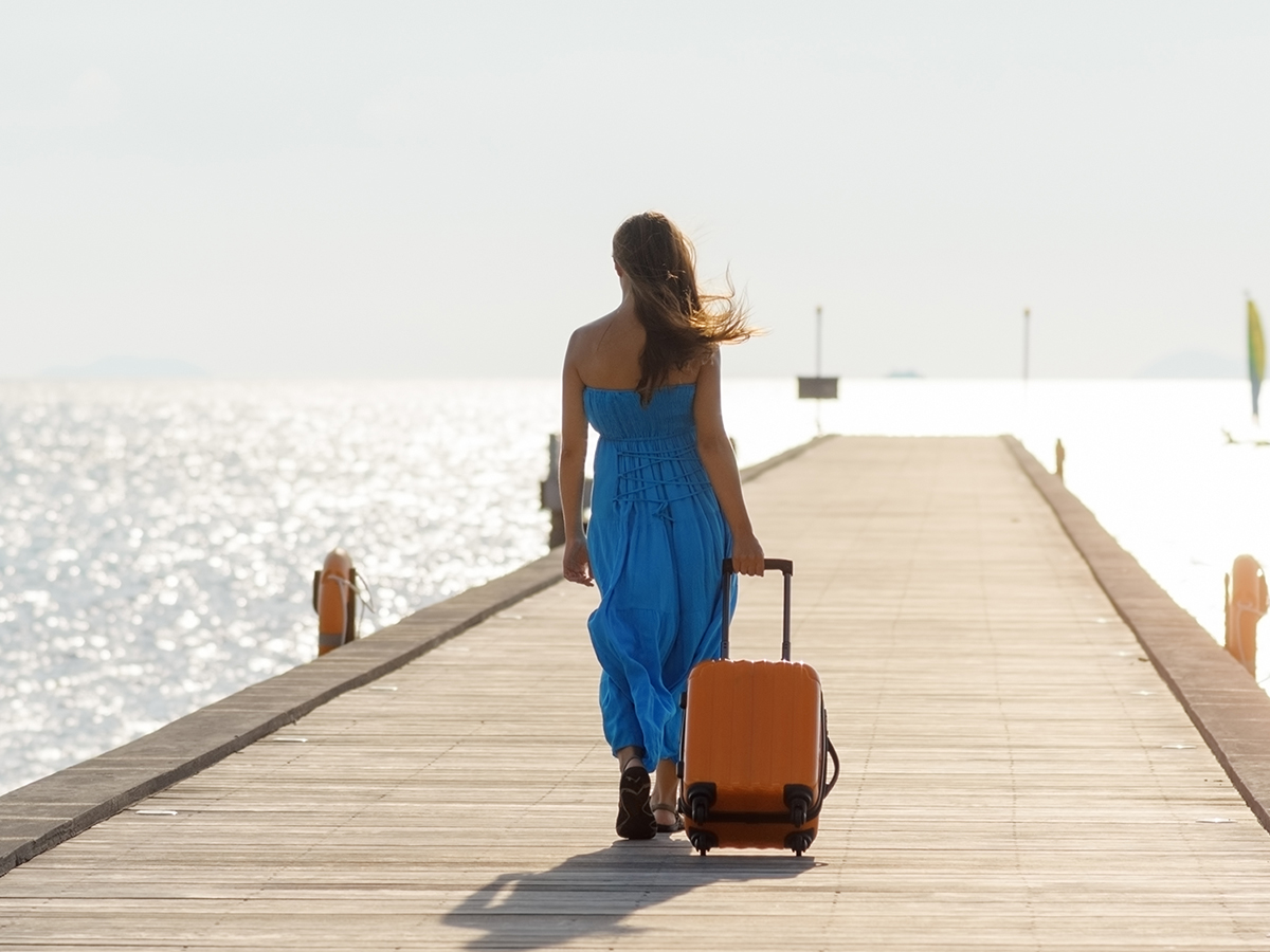Woman on dock with suitcase
